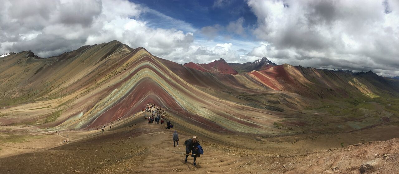 People walking towards Rainbow Mountain Peru viewpoint